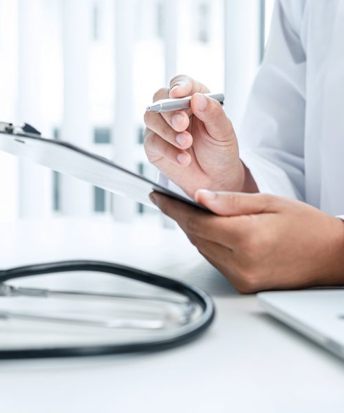 doctor-is-sitting-and-reading-medical-report-in-his-hospital-office.jpg